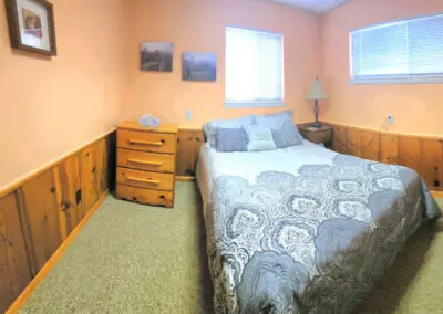 Bedroom with one queen bed in the LaVerna Hermitage lodge, a cozy retreat for up to 2 guests seeking a place to stay in Holly, Michigan.