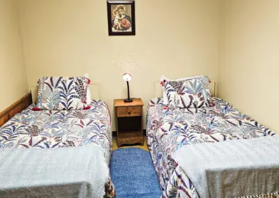 Bedroom with two twin beds in St. Felix Lodge at Maryville Retreat Center in Holly, Michigan.
