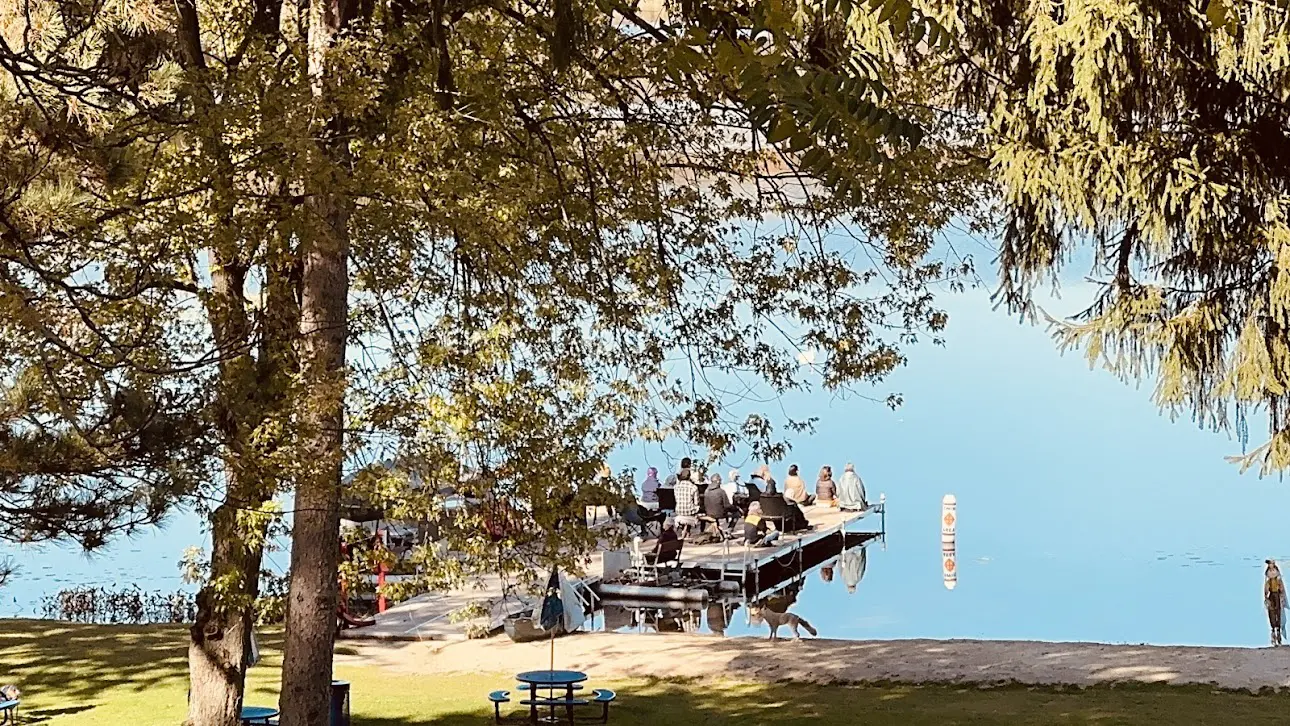 Guests sit quietly on the dock during a meditation retreat at Maryville Retreat Center, surrounded by peaceful lake views.