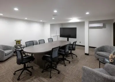A small conference room and library with tables and seating for quiet time or small group gatherings.
