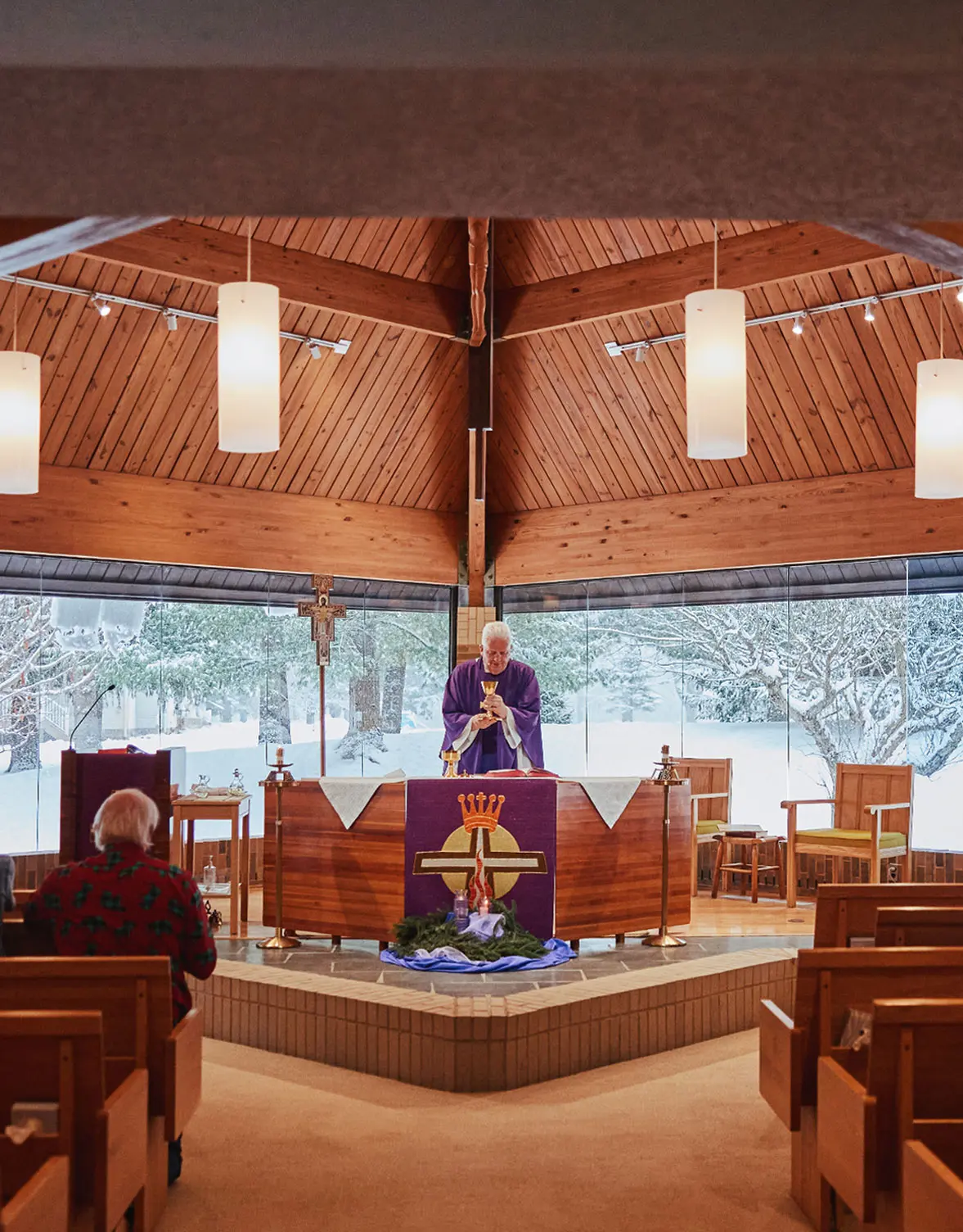 Priest presiding over Mass in a moment of prayer and reflection