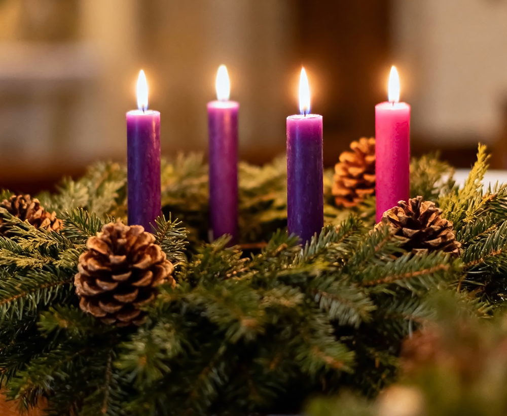 Four lit Advent candles at Maryville Retreat Center, symbolizing spiritual renewal and reflection during the Advent season.